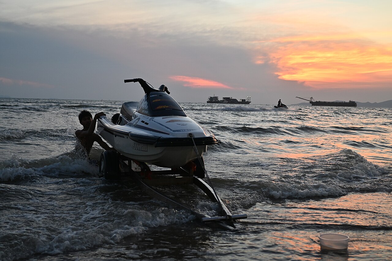 DFC 5144 Sunset launch a jet ski is pushed into the waves off Pattaya as the sky glows orange